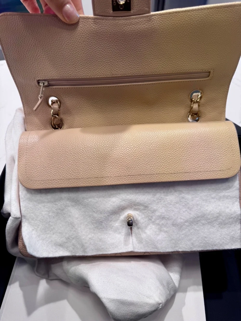Chanel Classic Medium Double Flap in beige nude caviar with gold tone hardware.